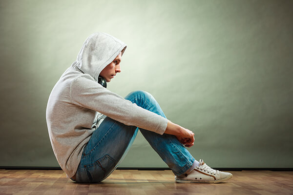 unhappy male teen in hoodie
