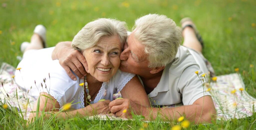senior couple snuggling outdoors