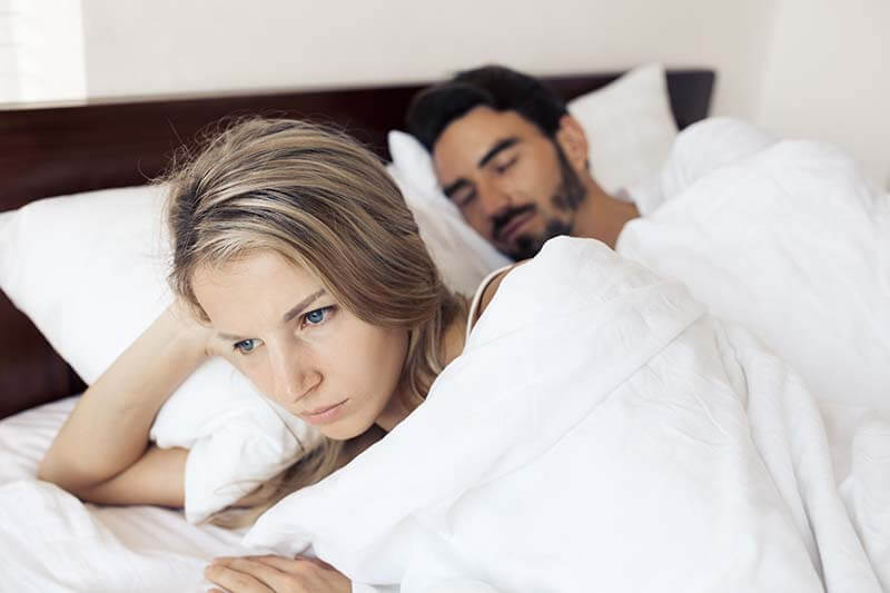 Unhappy couple having problems at bedroom family conflict