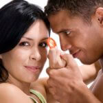 Close-up of a young couple holding a condom