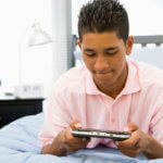 teenage boy in bed with phone