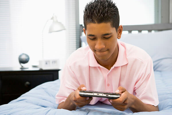 teenage boy in bed with phone