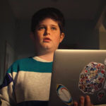 Young boy with laptop in hand