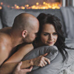 bald man with woman in bed