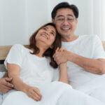 Happy Asian senior couple having good time at home