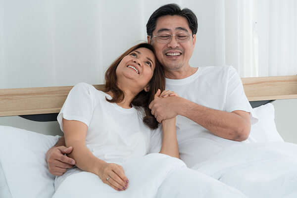 Happy Asian senior couple having good time at home