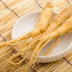 3 ginseng roots in a bowl on a table
